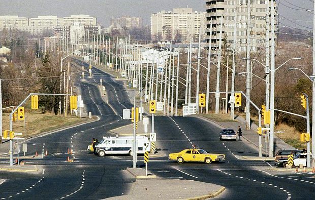 Deserted Mississauga highway during the evacuation, with police roadblock and apartment towers visible in the distance