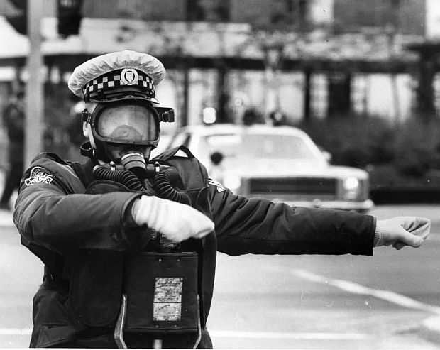Auxiliary policeman Neil Porter wearing a gas mask while directing traffic at Highways 10 and 5 during the Mississauga evacuation